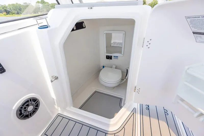 Slide: The Image of 2025 Sea Fox 268 Traveler boat interior with compact marine toilet and mirror. - 29