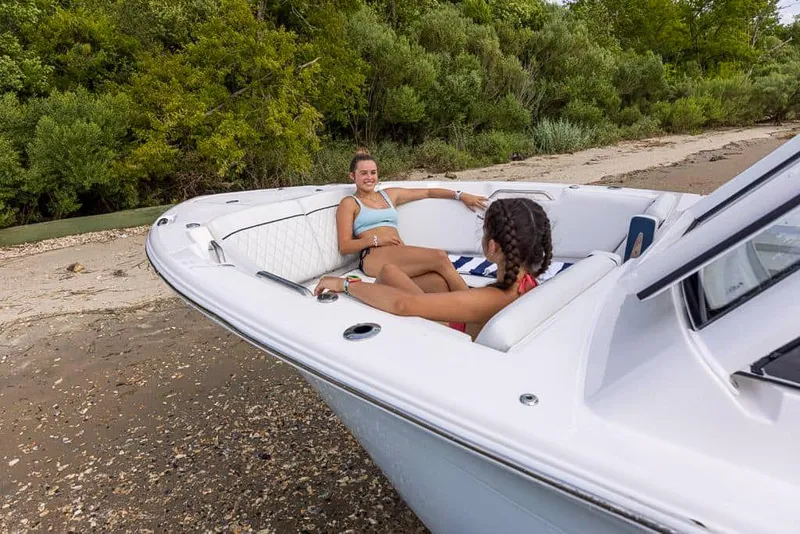 Slide: The Image of Two people relaxing on a 2025 Sea Fox 268 Traveler boat by the shore. - 8