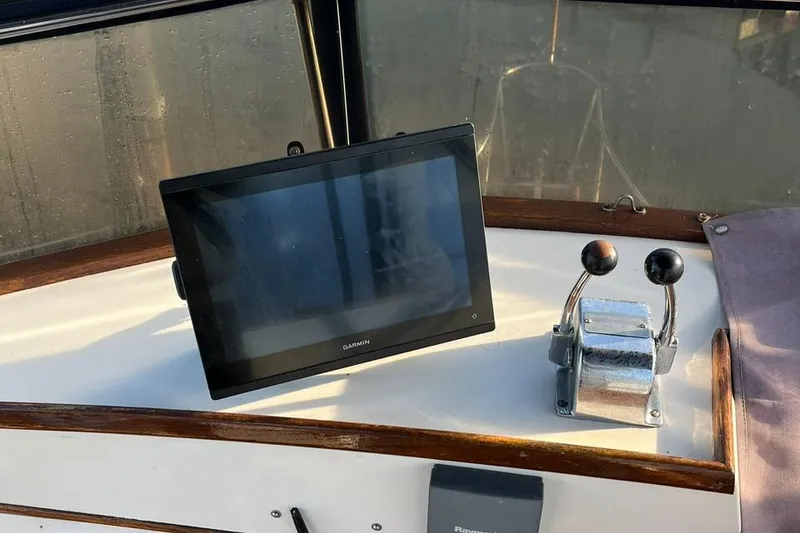 Slide: The Image of 1978 Grand Banks 38 helm with Garmin display and dual throttle controls. - 11