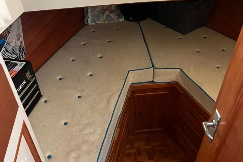 Slide: The Image of 1978 Grand Banks 38 cabin interior with V-berth and wooden cabinetry. - 14