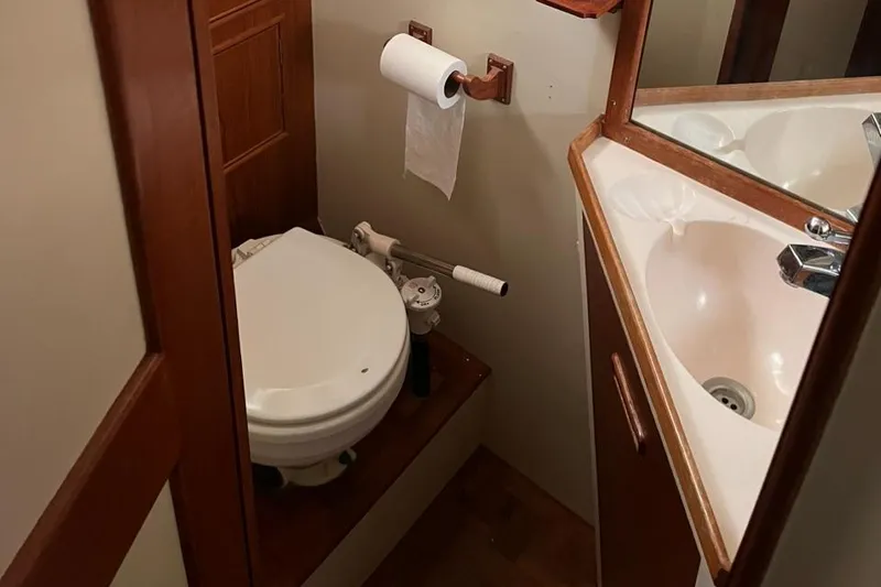 Slide: The Image of 1978 Grand Banks 38 yacht bathroom with toilet, sink, and wooden accents. - 16