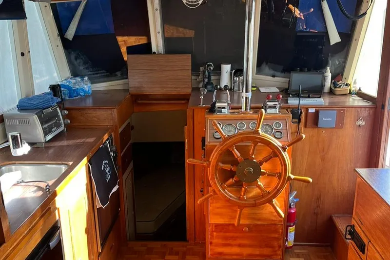 Slide: The Image of Interior of 1978 Grand Banks 38 boat with wooden helm and kitchen area. - 18