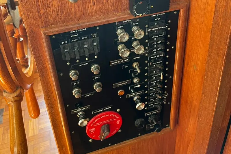 Slide: The Image of Control panel of a 1978 Grand Banks 38 boat with switches and dials. - 19
