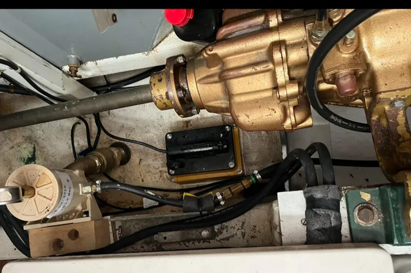 Slide: The Image of Engine compartment of a 1978 Grand Banks 38 boat, showing mechanical components and wiring. - 22
