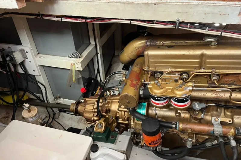 Slide: The Image of Engine room of a 1978 Grand Banks 38 boat, showcasing detailed mechanical components. - 23