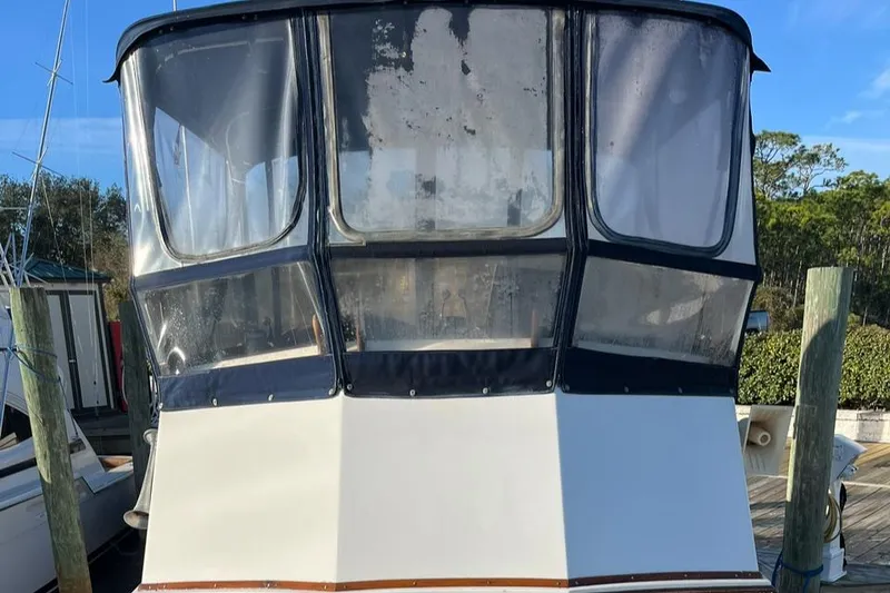 Slide: The Image of 1978 Grand Banks 38 boat with enclosed cockpit, docked at marina. - 3