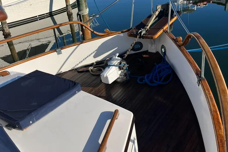 Slide: The Image of 1978 Grand Banks 38 boat deck with wooden railings and nautical equipment. - 4