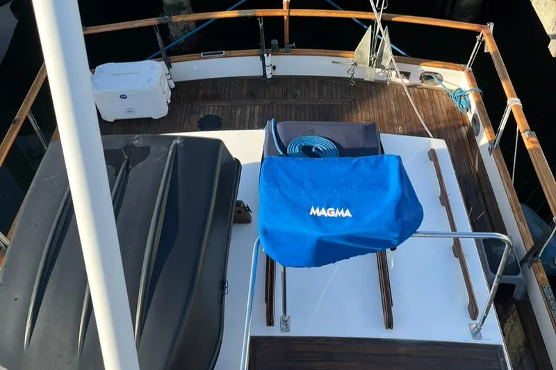 Slide: The Image of 1978 Grand Banks 38 yacht deck with Magma grill cover and wooden railings. - 9