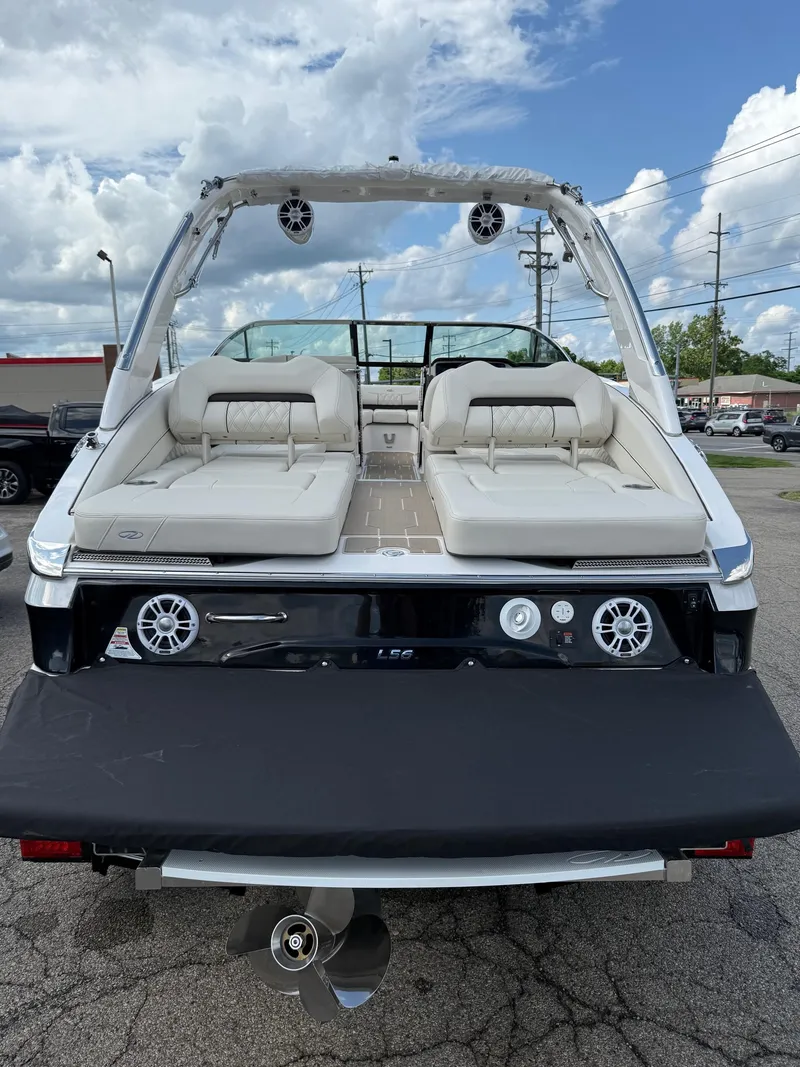 Slide: The Image of 2025 Regal LS6 boat with luxurious seating and modern design, displayed outdoors. - 14