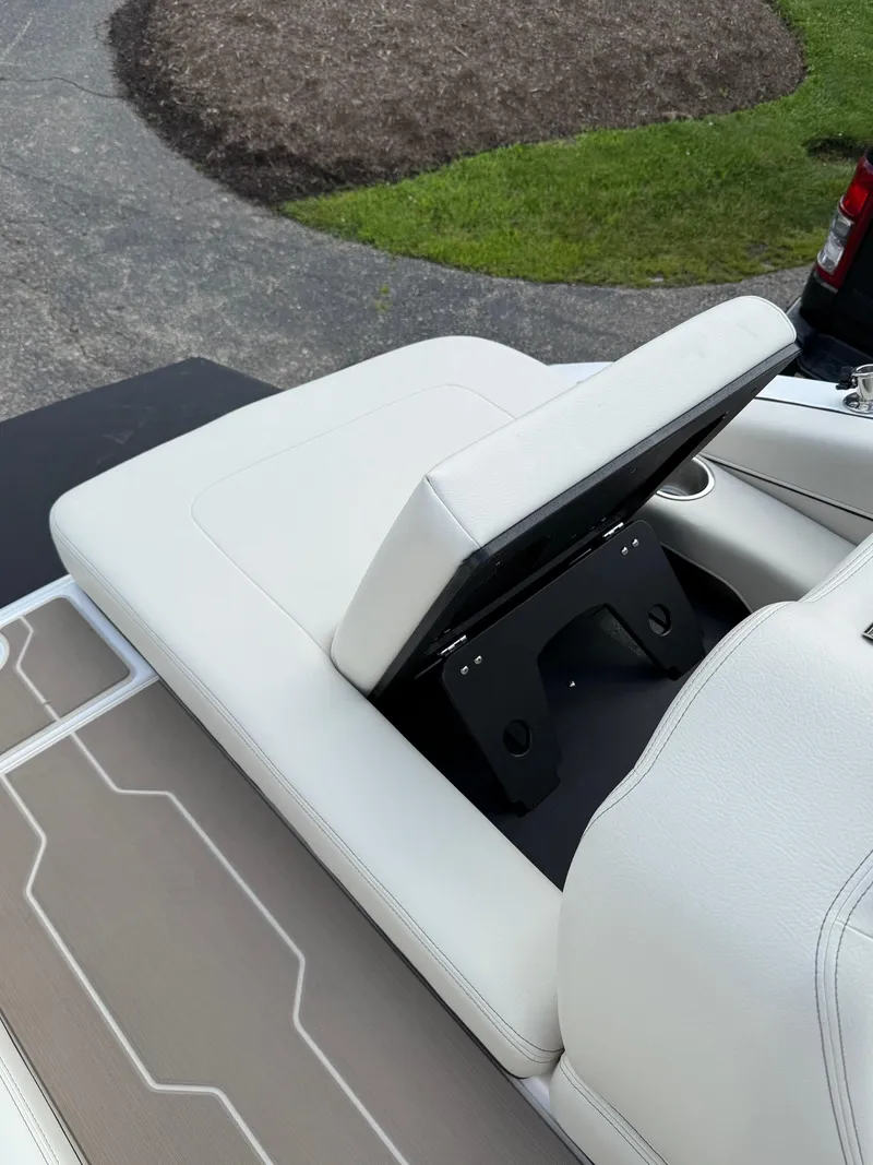 Slide: The Image of 2025 Regal LS6 boat seat with storage compartment, featuring white upholstery and modern design. - 6
