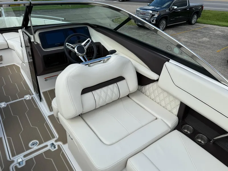 Slide: The Image of Luxurious interior of 2025 Regal LS6 boat with white leather seating and modern dashboard. - 8