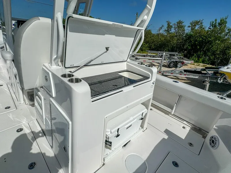 Slide: The Image of 2025 Sea Fox 328 Commander boat interior with open storage and cooler. - 11