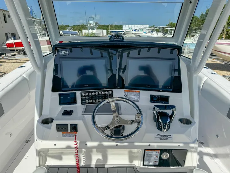Slide: The Image of 2025 Sea Fox 328 Commander helm with dual screens and modern controls. - 14