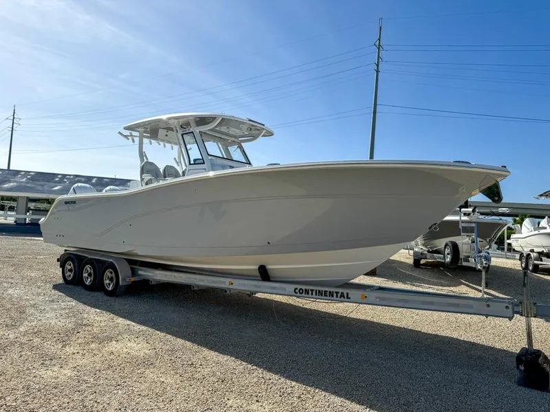 Slide: The Image of 2025 Sea Fox 328 Commander boat on trailer under clear blue sky. - 6