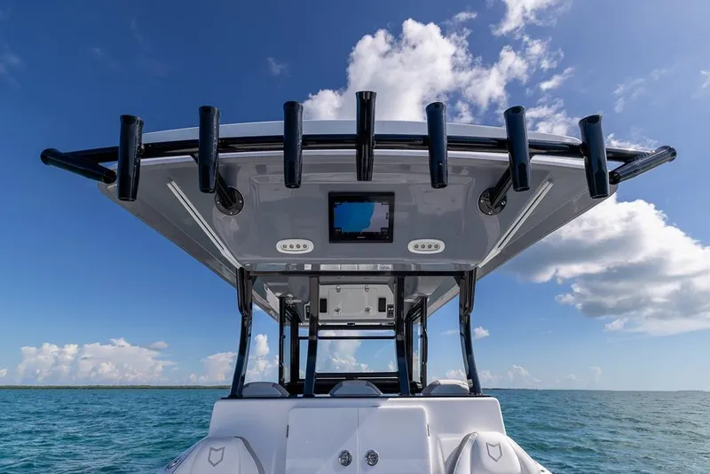 Slide: The Image of 2025 Sea Fox 368 Commander boat on open water under blue sky. - 25