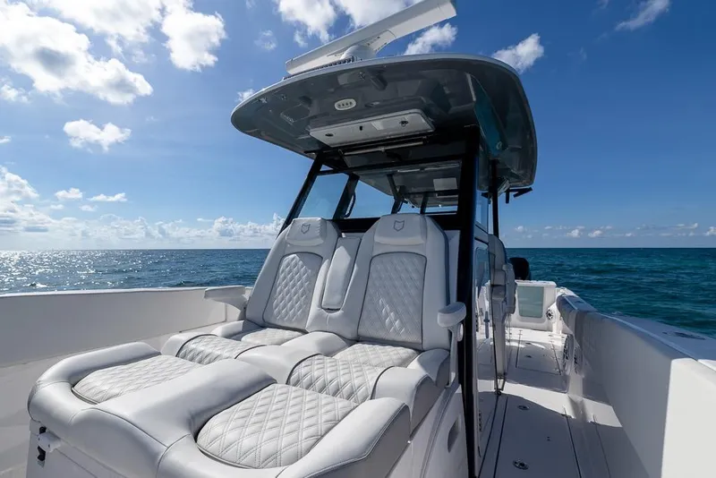 Slide: The Image of 2025 Sea Fox 368 Commander boat interior with luxurious seating, ocean view, and clear blue sky. - 32