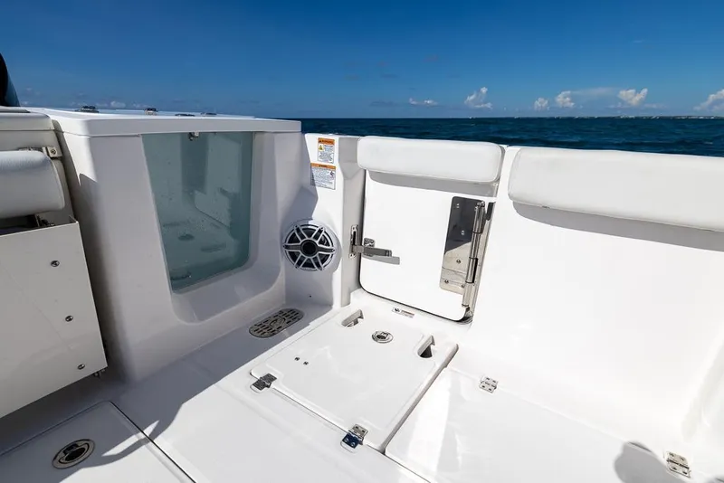 Slide: The Image of 2025 Sea Fox 368 Commander boat interior with ocean view, featuring seating and storage. - 34