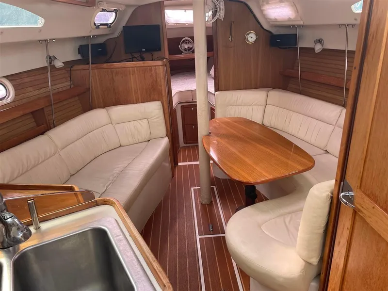 Slide: The Image of Interior of 2008 Catalina 320 MkII sailboat with wood accents and cozy seating. - 2