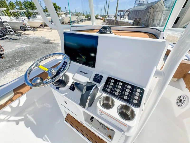 Slide: The Image of 2024 Caymas 26 HB boat console with steering wheel and control panel. - 17