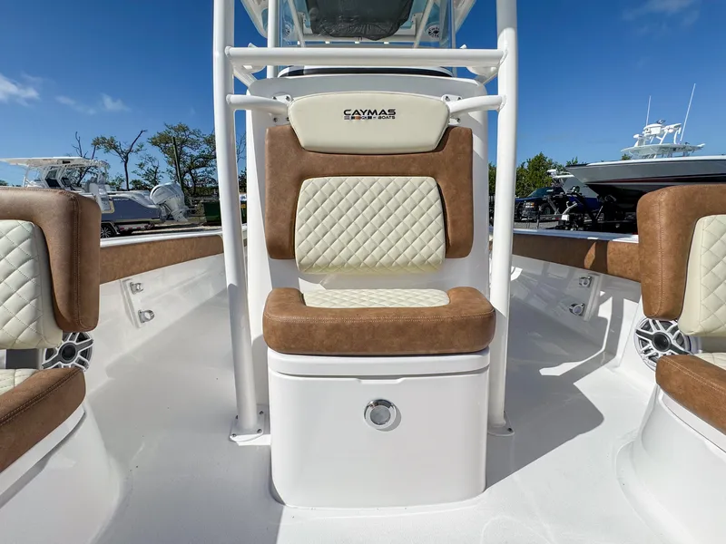 Slide: The Image of 2024 Caymas 26 HB boat interior with cushioned seating and sleek design. - 23
