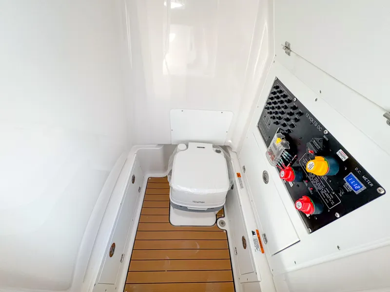 Slide: The Image of 2024 Caymas 26 HB boat interior with toilet and control panel. - 26