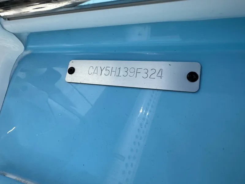 Slide: The Image of 2024 Caymas 26 HB boat identification plate on blue surface. - 29