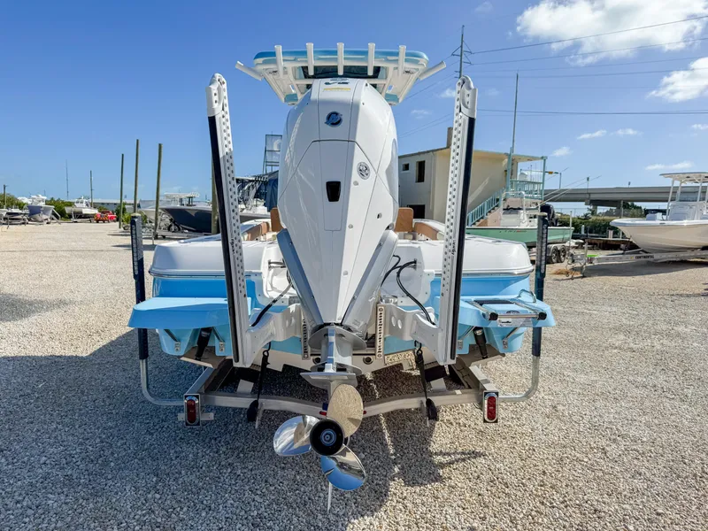 Slide: The Image of 2024 Caymas 26 HB boat, rear view, on trailer in sunny marina. - 4