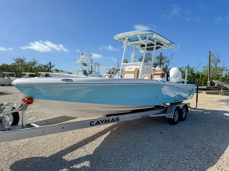 Slide: The Image of 2024 Caymas 26 HB boat on trailer, light blue hull, sunny day. - 7