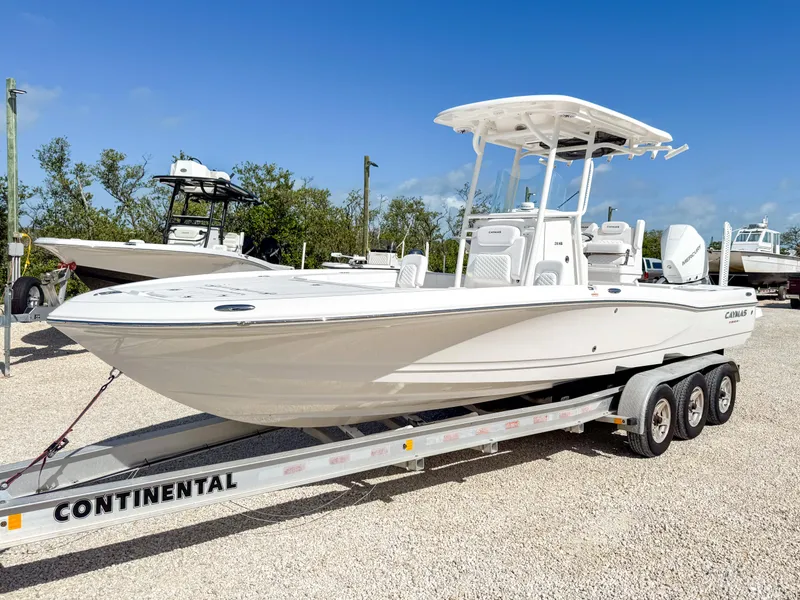 Slide: The Image of 2024 Caymas 26 HB boat on a Continental trailer, parked outdoors. - 1