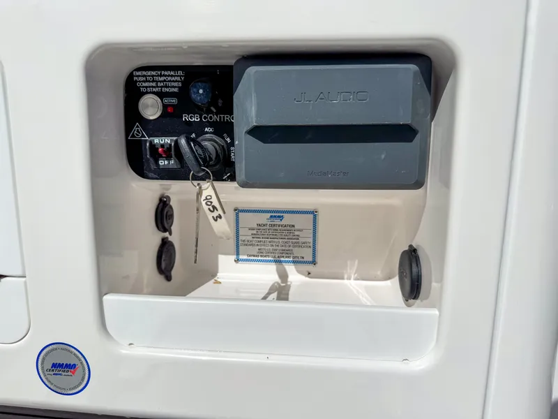 Slide: The Image of Control panel of a 2024 Caymas 26 HB boat with key and switches. - 15