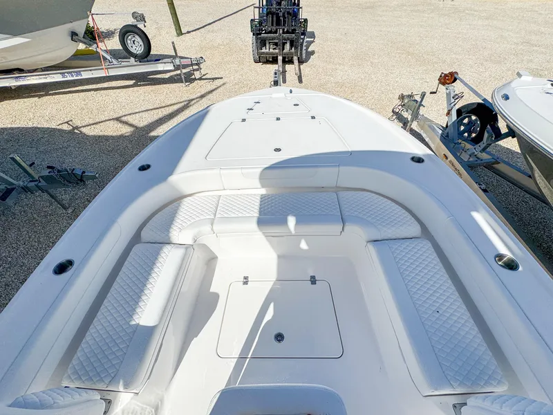 Slide: The Image of 2024 Caymas 26 HB boat deck with seating and storage compartments. - 17