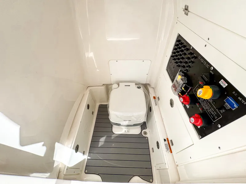 Slide: The Image of 2024 Caymas 26 HB boat interior with toilet and control panel. - 22
