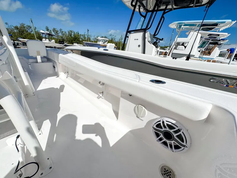 Slide: The Image of 2024 Caymas 26 HB boat interior with seating and speaker, under clear blue sky. - 24