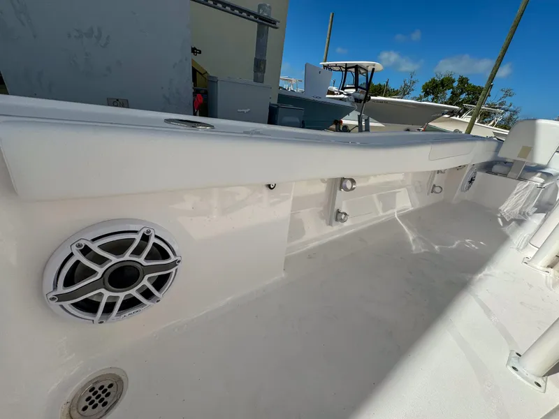 Slide: The Image of 2024 Caymas 26 HB boat interior with speaker and rod holders. - 25