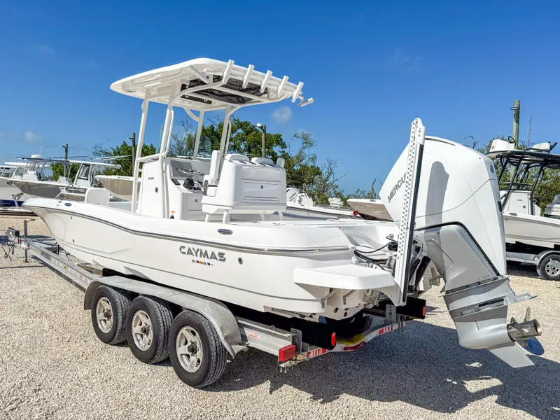 Slide: The Image of 2024 Caymas 26 HB boat on trailer, featuring sleek design and powerful outboard motor. - 3