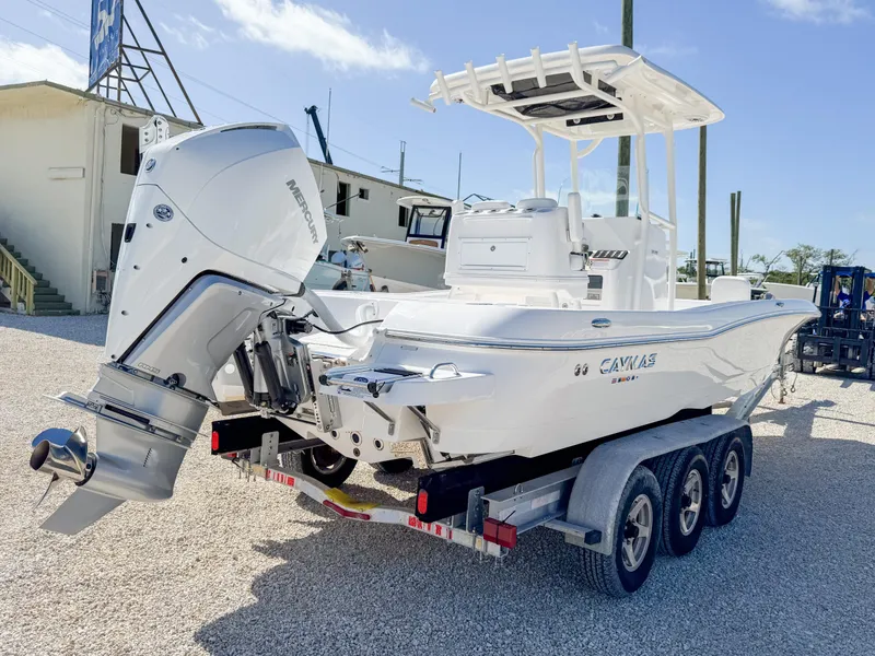 Slide: The Image of 2024 Caymas 26 HB boat on trailer, featuring powerful outboard motor. - 5