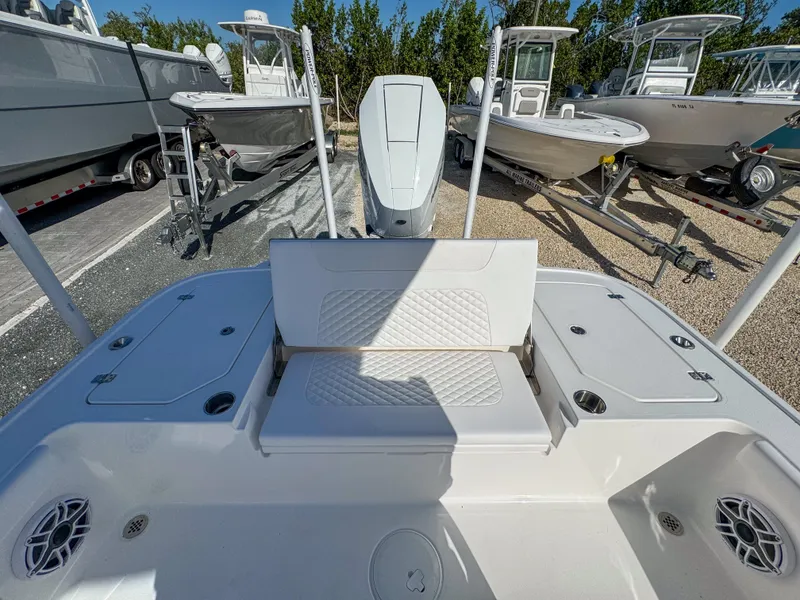 Slide: The Image of 2024 Caymas 28 HB boat interior with seating and storage compartments. - 11