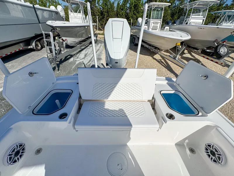 Slide: The Image of 2024 Caymas 28 HB boat interior with open storage compartments and seating. - 12