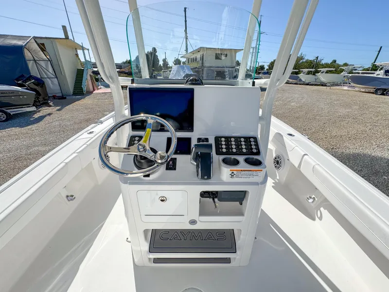 Slide: The Image of 2024 Caymas 28 HB boat console with steering wheel and controls. - 14