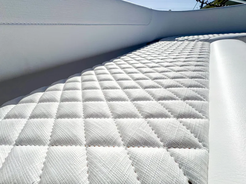 Slide: The Image of 2024 Caymas 28 HB boat interior with quilted white upholstery. - 24