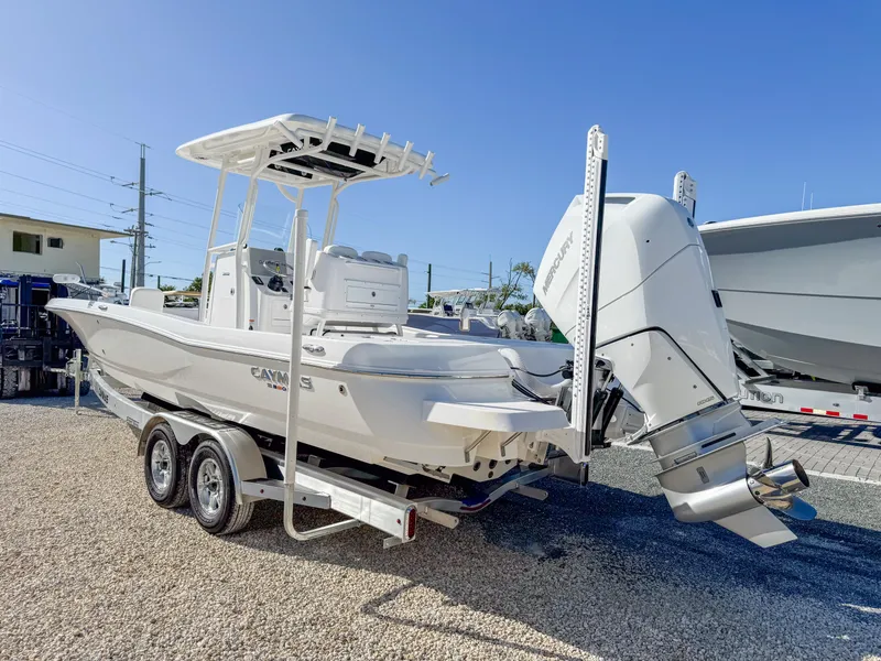 Slide: The Image of 2024 Caymas 28 HB boat on trailer, featuring a powerful outboard motor. - 3