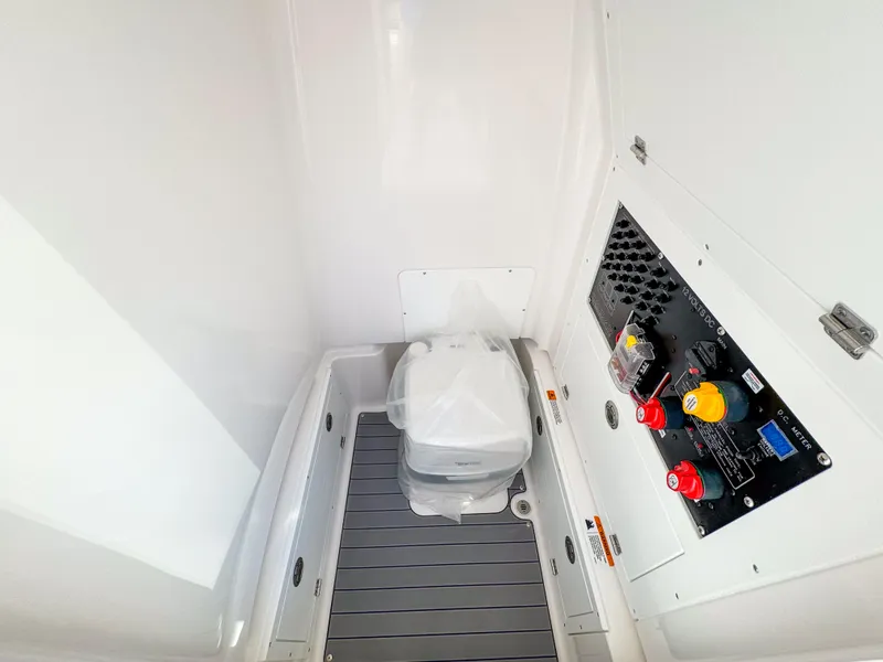 Slide: The Image of 2024 Caymas 28 HB boat interior with control panel and portable toilet. - 30
