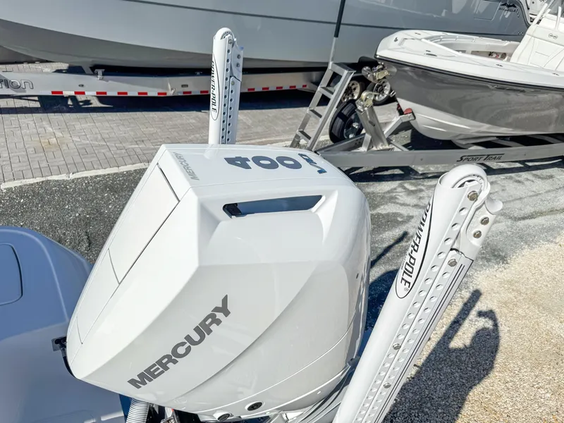 Slide: The Image of 2024 Caymas 28 HB with Mercury 400 outboard engine, docked on a trailer. - 33