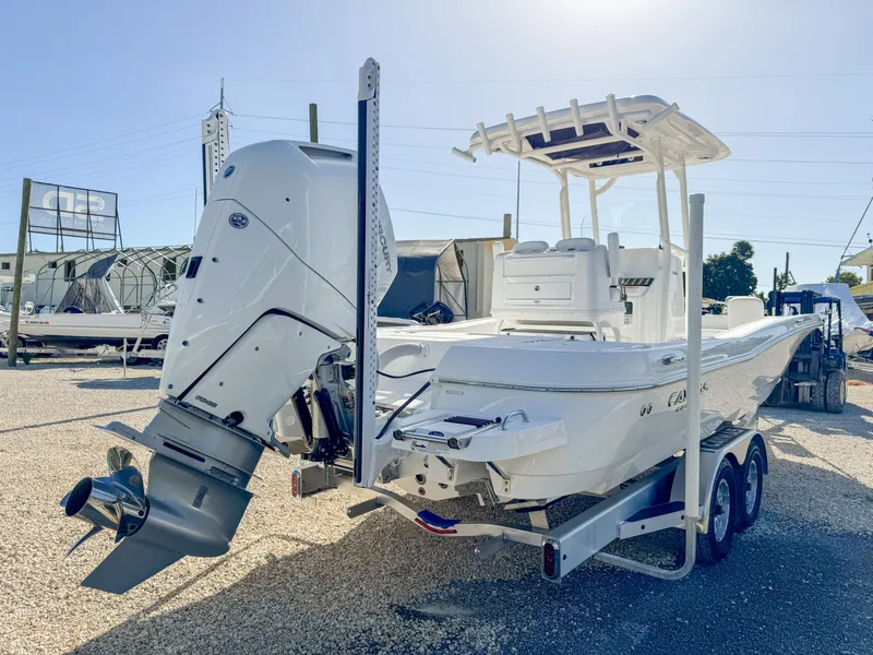 Slide: The Image of 2024 Caymas 28 HB boat on trailer, featuring powerful outboard motor. - 5