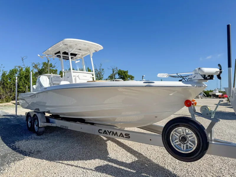 Slide: The Image of 2024 Caymas 28 HB boat on trailer under clear blue sky. - 7
