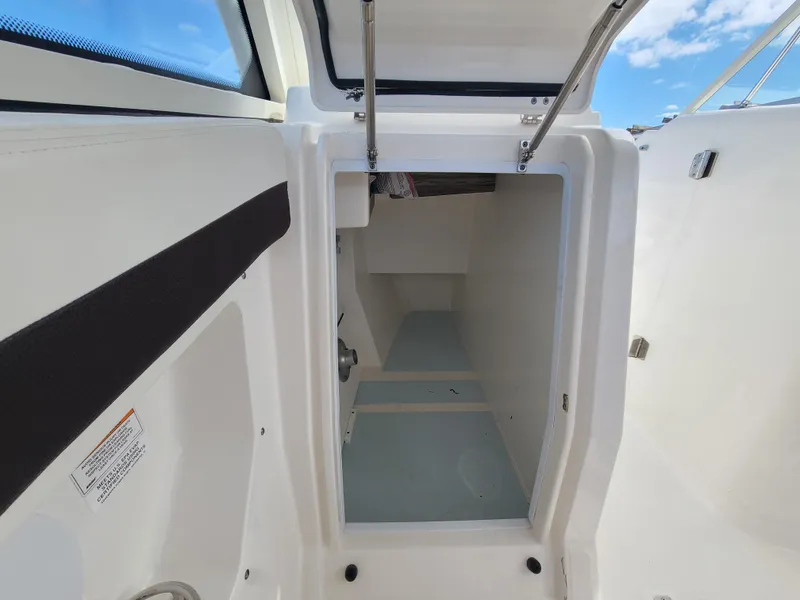 Slide: The Image of Interior cabin of 2018 Edgewater 262 CX boat, featuring clean white design. - 11