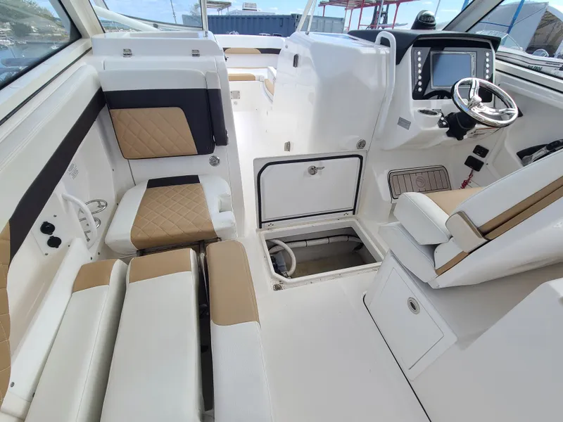 Slide: The Image of Interior of 2018 Edgewater 262 CX boat with modern seating and control panel. - 12