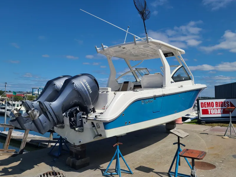 Slide: The Image of 2018 Edgewater 262 CX boat on display with twin outboard engines. - 3