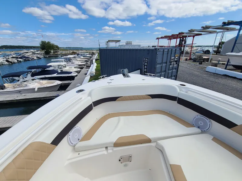 Slide: The Image of 2018 Edgewater 262 CX boat docked at marina under blue sky. - 4