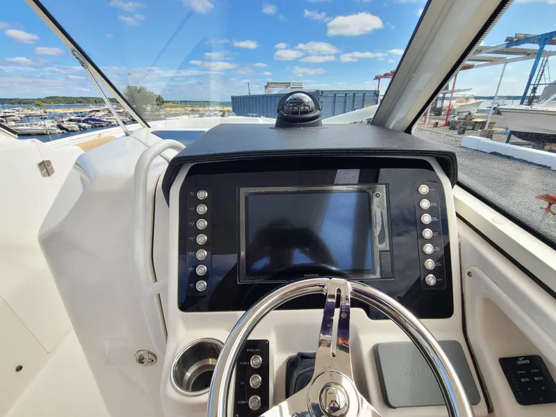 Slide: The Image of 2018 Edgewater 262 CX boat dashboard with steering wheel and navigation display. - 7